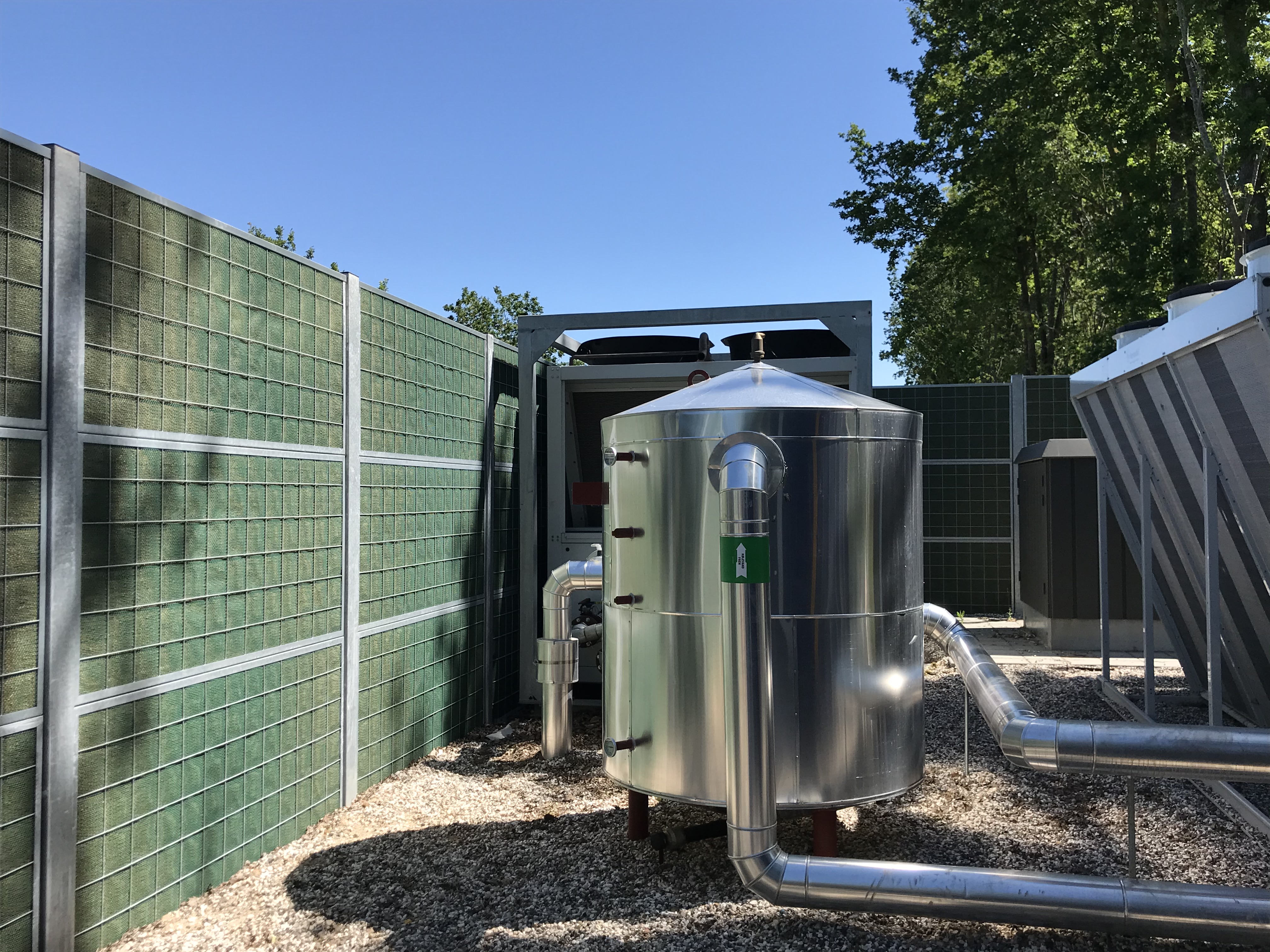 Et Noistop®-stålstøygjerde fra Poda Gjerder installert for å skjerme for støy fra en varmepumpe
